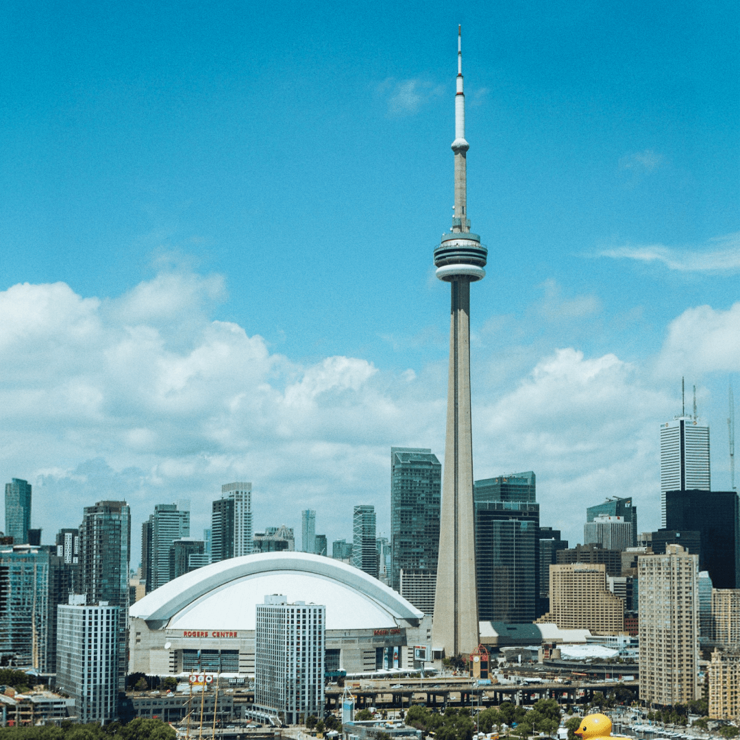 Toronto skyline with CN Tower and Rogers Centre under a blue sky