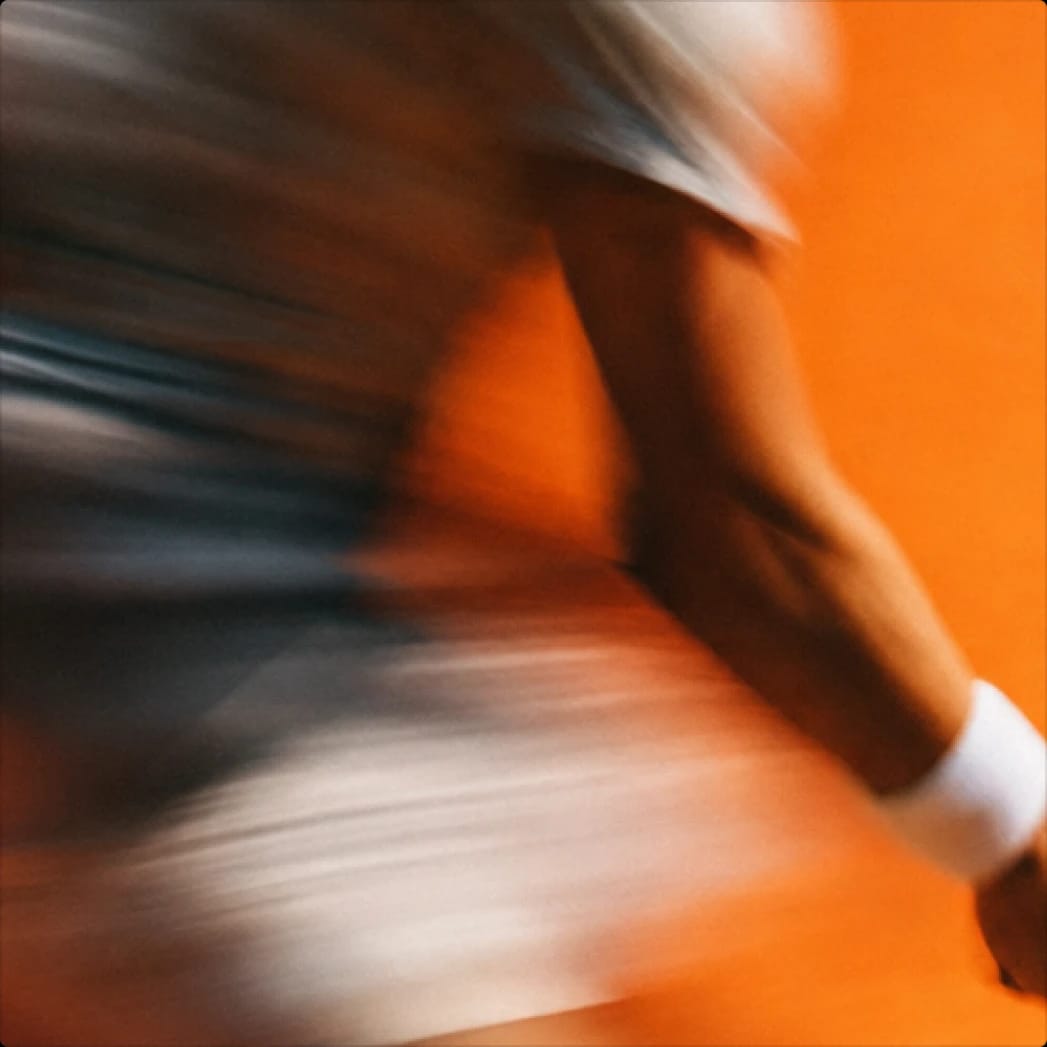 Motion-blurred person against an orange background