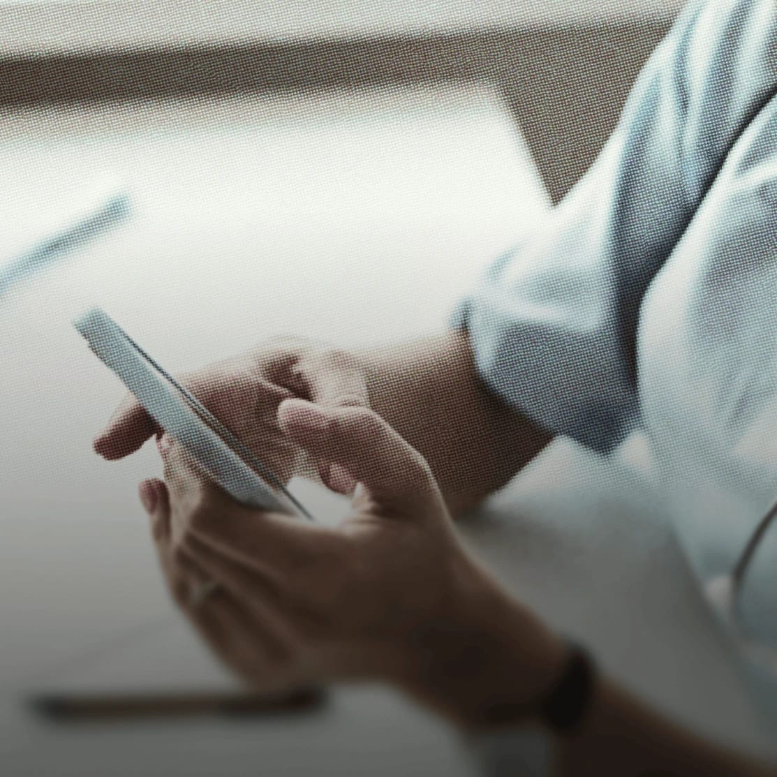 Person using a smartphone with a focus on their hands.