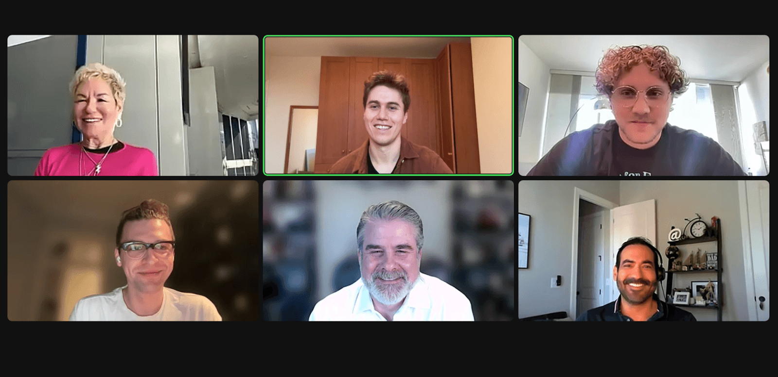 Six people smiling during a virtual meeting.